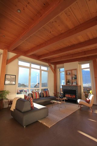 Spectacular views are seen from under the comfort of local Douglas fir timbers that form the main living room of Kevin Mooney, owner of BC Timberframe. - Allen Jones / ACE Film